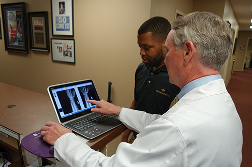 Dr. Joseph Wilkes, OrthoAtlanta and staff view X-ray